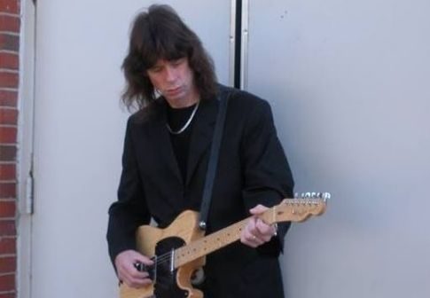 Photo of Scott Wahlberg holding his guitar