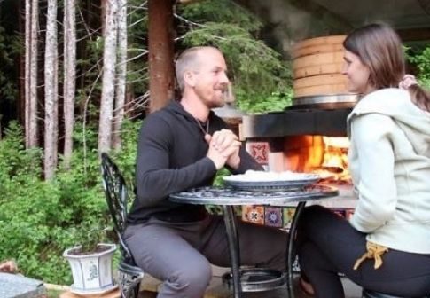 Jake and Nicole Mace enjoying their pizza near hot fire